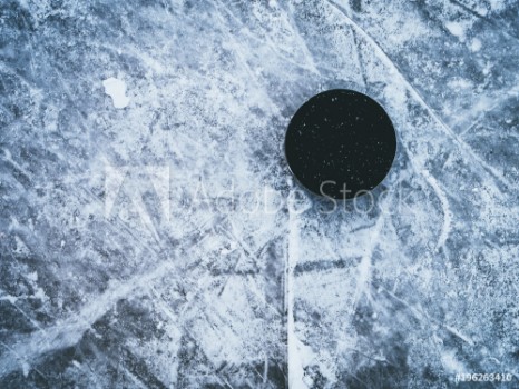 Bild på hockey puck on the ice and snow texture copyspace and text